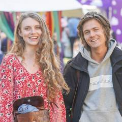 Two students side by side smiling at the camera