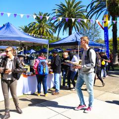 UQ students walking along food stalls