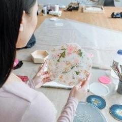 Woman holding flower resin coaster