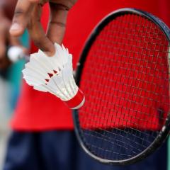 Badminton player holding racket with Badminton Shuttlecock.