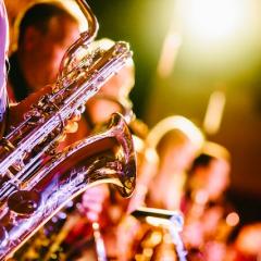 Brass instruments being played under spot light