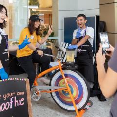 Student on a blender bike posing for a photo
