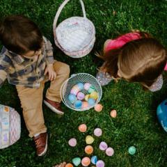 Small children playing with colourful plastic Easter eggs