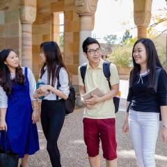 Group of happy international students walking through St Lucia campus