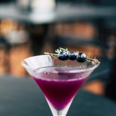 Purple cocktail with blue berries