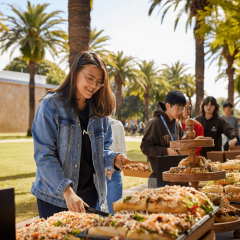 Students at the Gatton campus grabbing food from an event