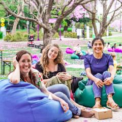 Students sitting on bean bags and smiling