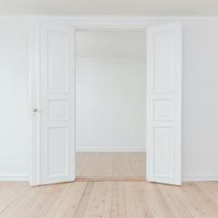 Two white open doors in an minimal clean empty room