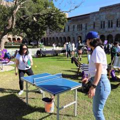 Two female students playing table tennis at the Great Court 