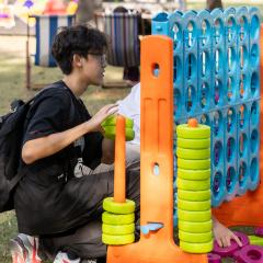 Student playing with an upsized Connect Four game